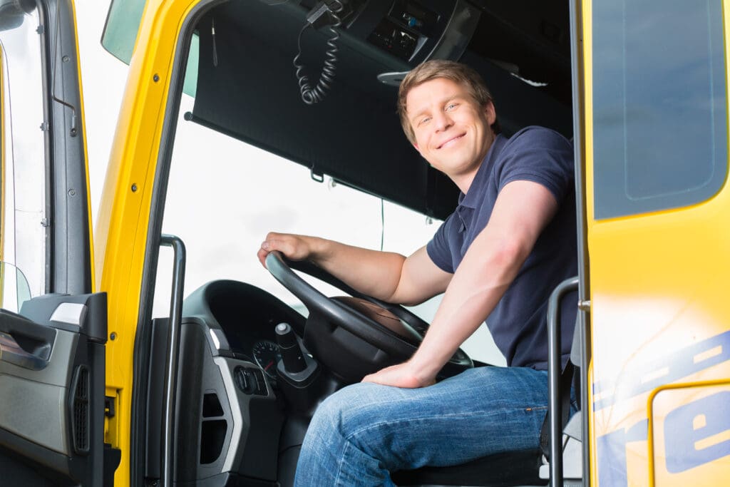 Forwarder or truck driver in drivers cap Kuvituskuva logistiikka-alan raskaankaluston kuljettajasta työssään